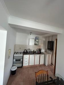 科尔多瓦Viaggiato Carlucci的厨房配有白色橱柜、炉灶和冰箱。