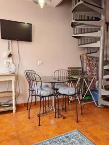 库迪列罗Casina del Puerto的用餐室配有桌椅和电视