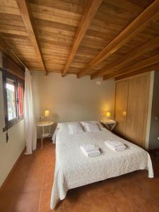 库迪列罗Casina del Puerto的一间卧室配有一张带两个水槽的床和木制天花板。