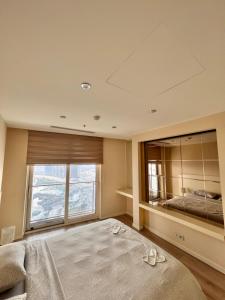 伊斯坦布尔Ottomare Suites sea, view, pool, gym的一间卧室设有一张大床和一个大窗户