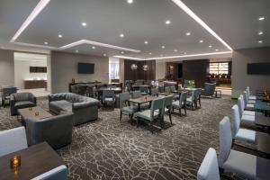 WestfieldSpringHill Suites by Marriott Indianapolis Westfield的一间带桌椅的餐厅和一间酒吧