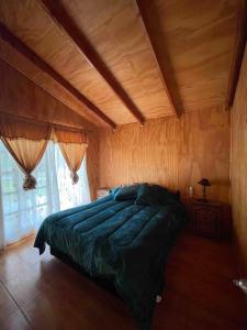 ChoapaComplejo Turístico Choapa Lindo的一间卧室设有一张带木制天花板的大床