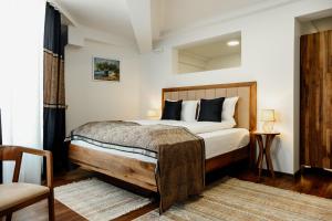 MaglajEdemus - Motel & Restaurant的一间卧室配有一张带木制床头板的床
