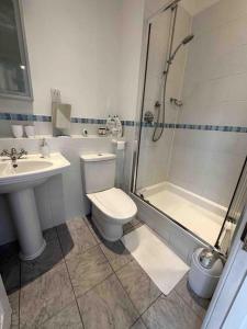 齐格威尔Luxury 2 BD, 2 BA on private gated Chigwell park的浴室配有卫生间、淋浴和盥洗盆。