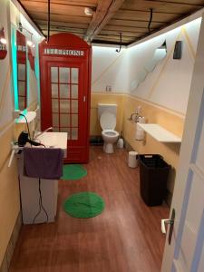 Münchenbuchsee思查博瑞尼旅馆的一间带红色电话亭和卫生间的浴室