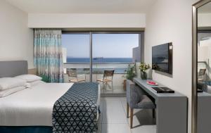 埃拉特Neptune Eilat By Dan Hotels的酒店客房设有一张床,享有海景。