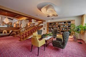 巴德小基希海姆普尔沃尔温泉酒店的一个带椅子和桌子的图书馆和一个楼梯