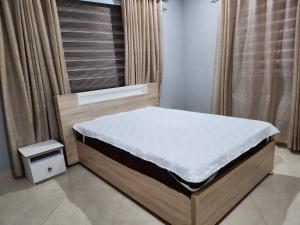 DawhwenyaSpacious Luxury 3Bed Hse in Tema - Netflix Wi-fi的一张位于带床垫的窗户的房间里的床
