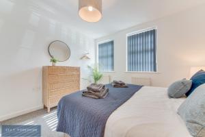 唐克斯特Stay Yorkshire Hamilton Mews Apartment的一间卧室配有床、镜子和梳妆台