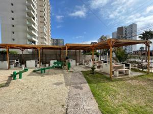 科金博Departamento Amoblado 3 Habitaciones的野餐区设有长椅和木制凉亭