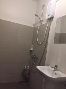 CogonMactan Airport Guesthouse的带淋浴和盥洗盆的浴室