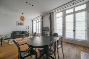 巴黎Appartement de Prestige - Grand Varenne的客厅配有桌椅和沙发