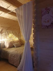 萨维尔纳Le Cottage OneHeart的一间卧室配有一张白色天蓬床