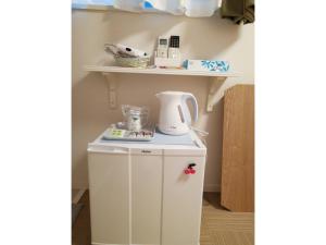 东京Tokyo stay Hut SARI - Vacation STAY 27260v的一个小白色橱柜,上面装有茶壶