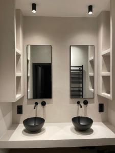 根特3 Bedroom Art-Nouveau Apartment with Free Parking的两个水槽,位于带两面镜子的柜台上