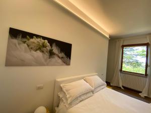 佩萨罗Villa Rina的卧室配有一张床,墙上挂有绘画作品