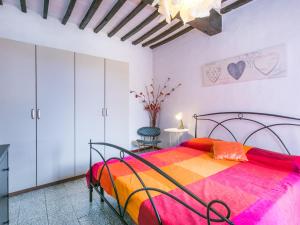蒙泰卡蒂尼瓦尔迪切奇纳Holiday Home La Vecchia Bottega by Interhome的一间卧室配有一张大床和色彩缤纷的毯子