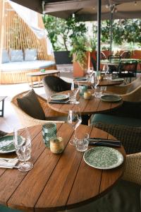 罗马罗马科索里亚斯特美居酒店的一张木桌,上面有玻璃杯和盘子