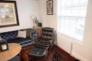 伯灵顿2Bdrm Victorian Style Tiny Home - long stays U7的客厅配有真皮沙发和椅子