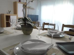 阿斯托加INSULA PLAzA MAYOR HOME的酒杯桌子和盘子