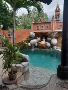 八丹拜Villa Manouria - Marcel的一座带瀑布的别墅内的小型游泳池