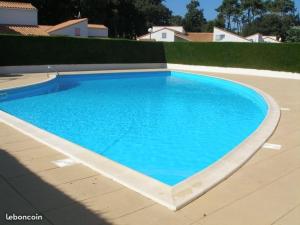 滨海雅尔Maison Jard-sur-Mer, 3 pièces, 5 personnes - FR-1-485-78的院子里的大型蓝色游泳池