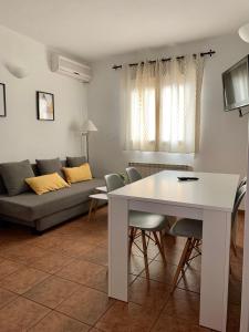埃尔瓦拉卡利加公寓的客厅配有白色桌子和沙发