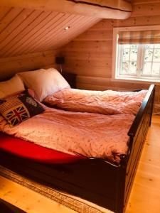 KvamNydelig hytte på Kvamskogen, nær Hardangerfjorden的小木屋内一间卧室,配有一张床