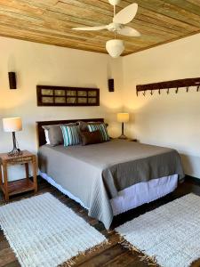 蒂拉登特斯Chalés Cores da Mata的一间卧室设有一张木天花板床。