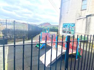 伯肯黑德Merseyside的围栏前带滑梯的游乐场