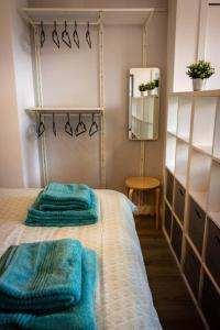 格拉斯哥Modern bright studio apartment in south Glasgow的一间设有床铺的房间,上面有两条毛巾