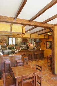 Villanueva de OscosHOTEL RURAL OSCOS的餐厅内的厨房配有木桌和椅子