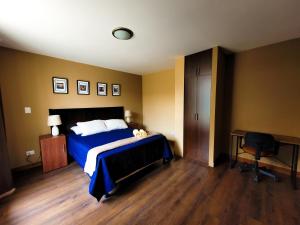 危地马拉Apartamentos 649的一间卧室配有一张床、一张桌子和一把椅子