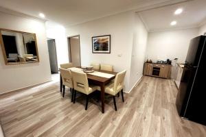 特里格尔The Retreat Terrigal 3bed 100m to beach的一间带桌椅和冰箱的用餐室