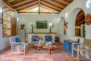 阿约拉港Enchanted Galapagos Lodge的客厅配有蓝色的椅子和桌子