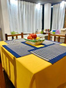 LozanoLa Pichonita的黄色桌子上放着一碗水果