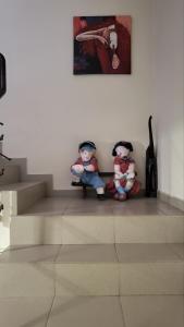 辛尼莫雷特Къща за гости Алекс的两个娃娃坐在楼梯下面的画作下