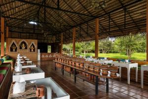 锡吉里亚Ayurvie Sigiriya - Ayurvedic Retreat by Thema Collection的一间带长桌和椅子的餐厅