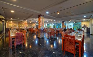 萨瓦伊马多普尔Spree Jungle Vilas Resort Ranthambore的一间设有木桌和椅子的餐厅