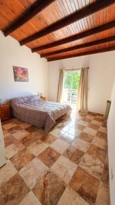阿肖海Acacias的一间卧室配有一张床,铺有一个 ⁇ 板地板
