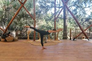 塔里法TAIGA Tarifa的一位在木甲板上做瑜伽姿势的女人