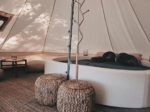 "Žvaigždžių slėnis"- glamping palapinė的帐篷内的一个床位,有两张木柴