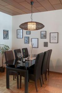 特里尔Casa Benedicta的餐桌、黑色椅子和吊灯