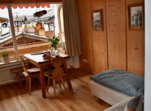 加尔米施-帕滕基兴Apartment Pfanzelter的客房设有桌子、床、床和桌椅。