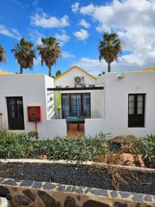 卡勒达德福斯特Casa Azul Montecastillo L7的一座棕榈树成荫的白色房子