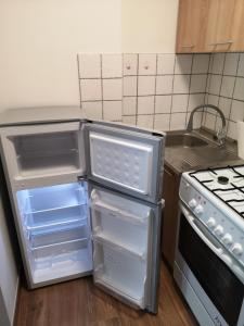 克罗斯诺Apartament przy dworcu的厨房配有开放式冰箱和炉灶。
