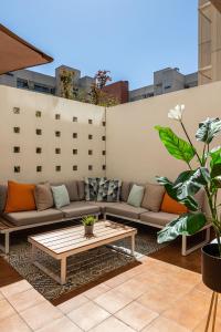 马德里BNBHolder Terrace, Pool & Gym LAS TABLAS的天井配有沙发和咖啡桌。