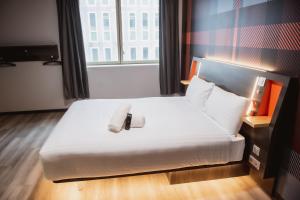 奥贝维利埃easyHotel Paris Nord Aubervilliers的一间酒店客房,配有一张带毛巾的床