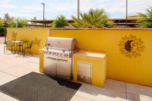 嘉年TownePlace Suites by Marriott Phoenix Goodyear的黄色的墙壁,配有炉灶和桌子
