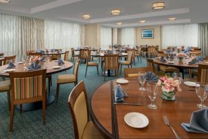 大洋城海洋城海滨万怡酒店的用餐室配有桌椅和鲜花